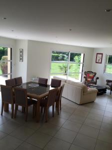 a living room with a table and chairs and a couch at Villa Benodet in Bénodet