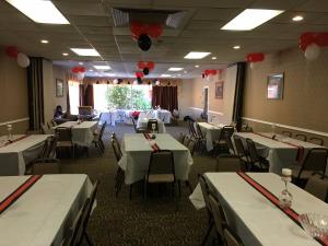 a dining room with tables and chairs and red balloons at Baymont by Wyndham Walterboro in Walterboro