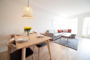 a living room with a table and a couch at BJØRVIKA APARTMENTS, Damsgård Area, Bergen city center in Bergen