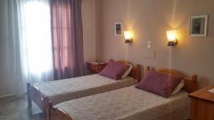 A bed or beds in a room at Vrohaki Studios & Rooms