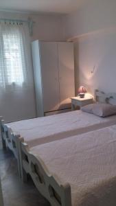 A bed or beds in a room at Vrohaki Studios & Rooms