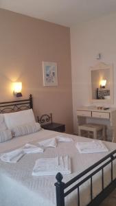 A bed or beds in a room at Vrohaki Studios & Rooms