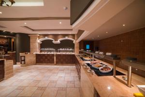 a restaurant with a buffet line with food at Maritim Antonine Hotel & Spa in Mellieħa