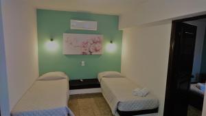 a room with two beds and a green wall at Doras Zante Studios & Apartments in Argassi