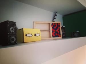 a shelf with a speaker and a box on it at U'Cuntu affittacamere in Favignana