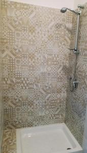 a bathroom with a shower with a white tub at U'Cuntu affittacamere in Favignana +47 photos