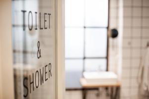 a door with a sign that reads life and shower at Woodah Boutique Hostel in Copenhagen