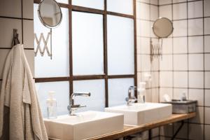 a bathroom with a sink and a mirror at Woodah Boutique Hostel in Copenhagen