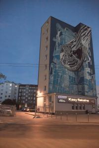 a building with a mural on the side of it at Apartament Kotwica in Gdynia