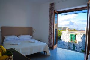 a bedroom with a bed and a view of a balcony at Hotel Europa in Ischia