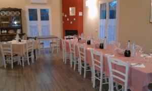 a dining room with tables and chairs with wine glasses at Agriturismo Poggio Sassineri in Magliano in Toscana