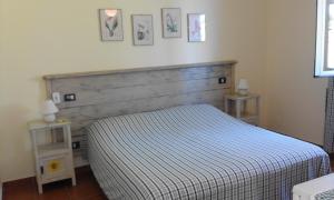 Postel nebo postele na pokoji v ubytování Agriturismo Poggio Sassineri