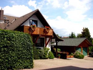 a house with a balcony with flowers on it at Apartmenthaus - Haus am Schultal in Braunlage