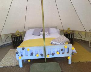 a bedroom with a bed in a tent at Cefn Crib Glamping in Machynlleth