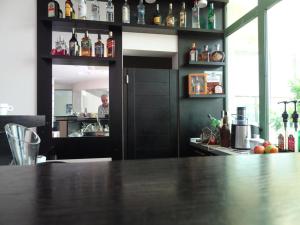 a kitchen with a bar with a man in the background at Alexander Lozenets Beach Complex Apartment in Lozenets