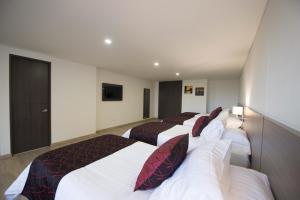Postel nebo postele na pokoji v ubytování SM Grand Hotel
