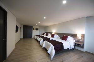 Postel nebo postele na pokoji v ubytování SM Grand Hotel