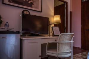 a computer monitor sitting on a desk with a chair at Colonial 154 H Boutique in Santo Domingo