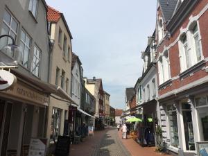 a street in a town with people walking down the street at Captains Lounge in Eckernförde
