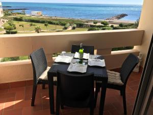 a table and chairs with a view of the ocean at Res Port St.Ange in Le Barcarès