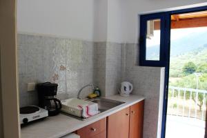 a kitchen counter with a sink and a window at Villa Bella Vista in Marathias