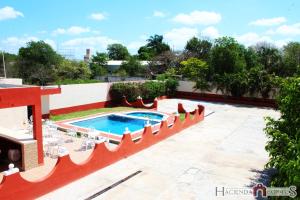 a swimming pool on the roof of a building at Hotel Hacienda Cortes in Mérida