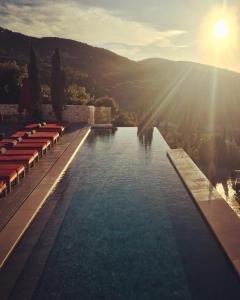 a swimming pool with a view of a mountain at Emelisse Nature Resort in Fiskardho