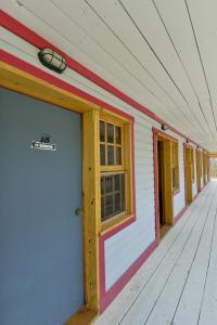a blue and white building with a red door at The Bunkhouse in Dawson City