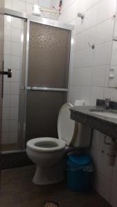 a bathroom with a toilet and a shower and a sink at Hotel Lund in Lagoa Santa +26 photos