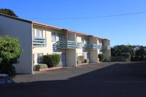 a building with balconies on the side of it at Coronation Court Motel in New Plymouth