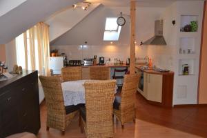 a kitchen with a table and chairs in a room at Apartament Centrum in Augustów