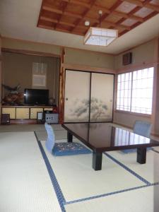 a living room with a table and chairs at Ryokan Sarashinaya in Kiso +7 photos