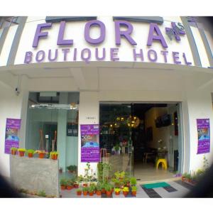 a store front with a sign that says, "don't be afraid to at Hotel Flora Plus in Cameron Highlands