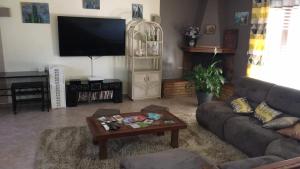a living room with a couch and a coffee table at B&B Macchia Verdata avec piscine in Monacia-dʼAullène