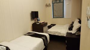 Katil atau katil-katil dalam bilik di Seasons Hotel - Causeway Bay