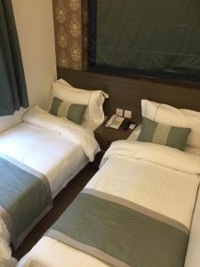 Katil atau katil-katil dalam bilik di Seasons Hotel - Causeway Bay