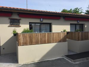 a house with a fence and a sign on it at Les studios du Centre in La Teste-de-Buch