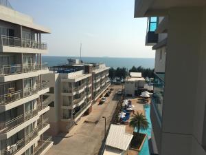 an aerial view of a street with buildings and the ocean at Grand Blue Condominium by Nuttaya in Klaeng