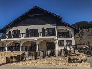 a large building with a balcony on top of it at Luisenthal Conac in Fundu Moldovei