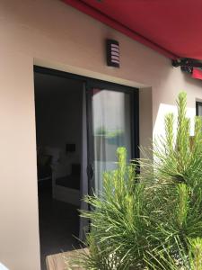 a sliding glass door of a house with plants at Les studios du Centre in La Teste-de-Buch