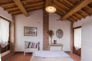 カステルフィオレンティーノにあるBrotafalchi Agriturismoのベッドルーム1室(ベッド1台、椅子1脚付)