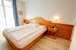 Postel nebo postele na pokoji v ubytování Hotel Garni Sottobosco