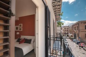 a bedroom with a bed on a balcony at B&B Dietro il Teatro in Palermo