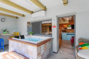 a kitchen with a hot tub in a room at Out of Africa Resort in Had Nes