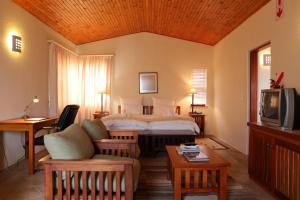 a hotel room with a bed and a tv at R&ouml;ssmund Lodge in Swakopmund