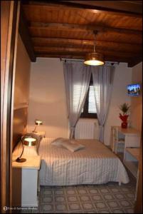 sypialnia z łóżkiem i oknem w obiekcie b&b Caravella w mieście Mezzojuso