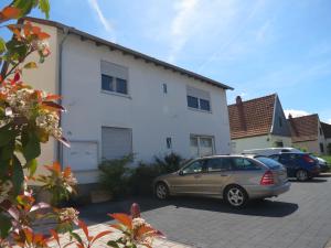 a car parked in front of a white house at Spira House in Speyer
