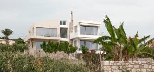 a white house with trees in front of it at ILIOS H&E house in Elia Laconias