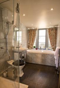 a bathroom with a tub and a toilet and a sink at Mingary Castle - Restaurant with Rooms in Kilchoan