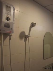 a hair dryer in a bathroom with a mirror at Lodge 61 Hotel in Bangkok +45 photos
